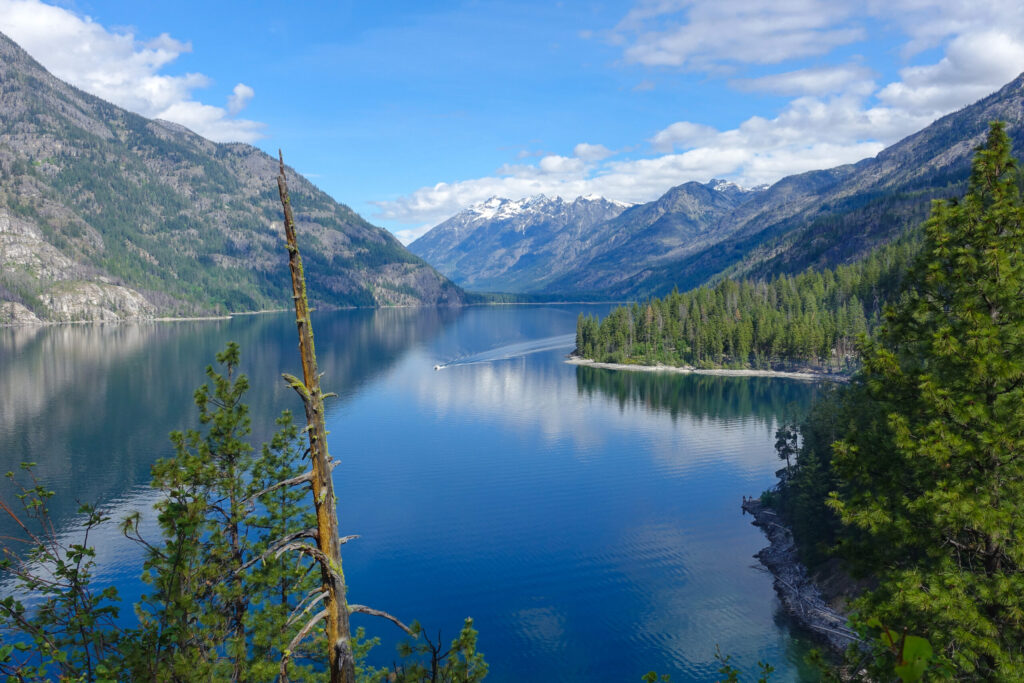 "Hiking the Lakeshore Trail with views of Lake Chelan’s deep blue water and pine-covered slopes"