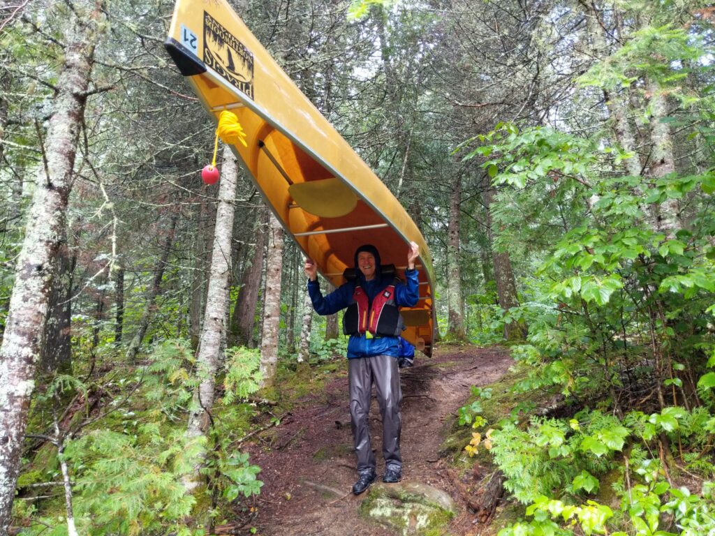 Portaging a canoe between lakes